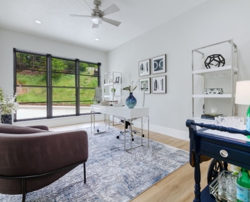 A stylish home office design in Boise featuring a desk, chair, and shelves, designed for productivity and comfort.