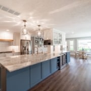 Kitchen with white cabinets and skylight, creating a bright and airy space.