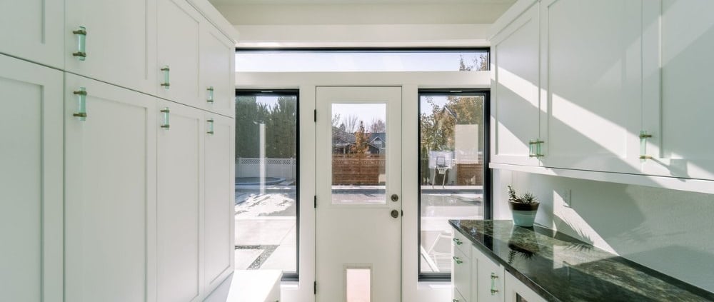 Kitchen with white cabinets and skylight, creating a bright and airy space.