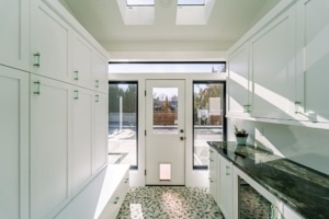 Kitchen with white cabinets and skylight, creating a bright and airy space.