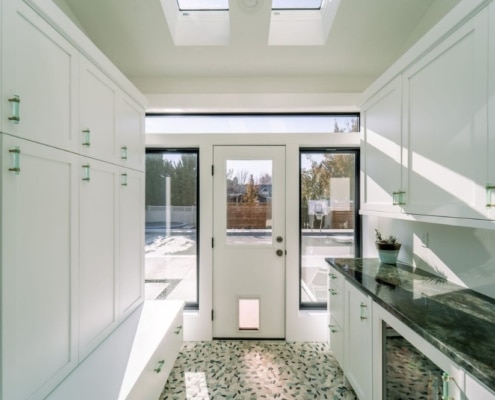 Kitchen with white cabinets and skylight, creating a bright and airy space.