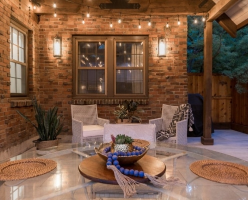 A serene patio with a pergola and comfortable chairs, providing a perfect spot for relaxation and outdoor gatherings.